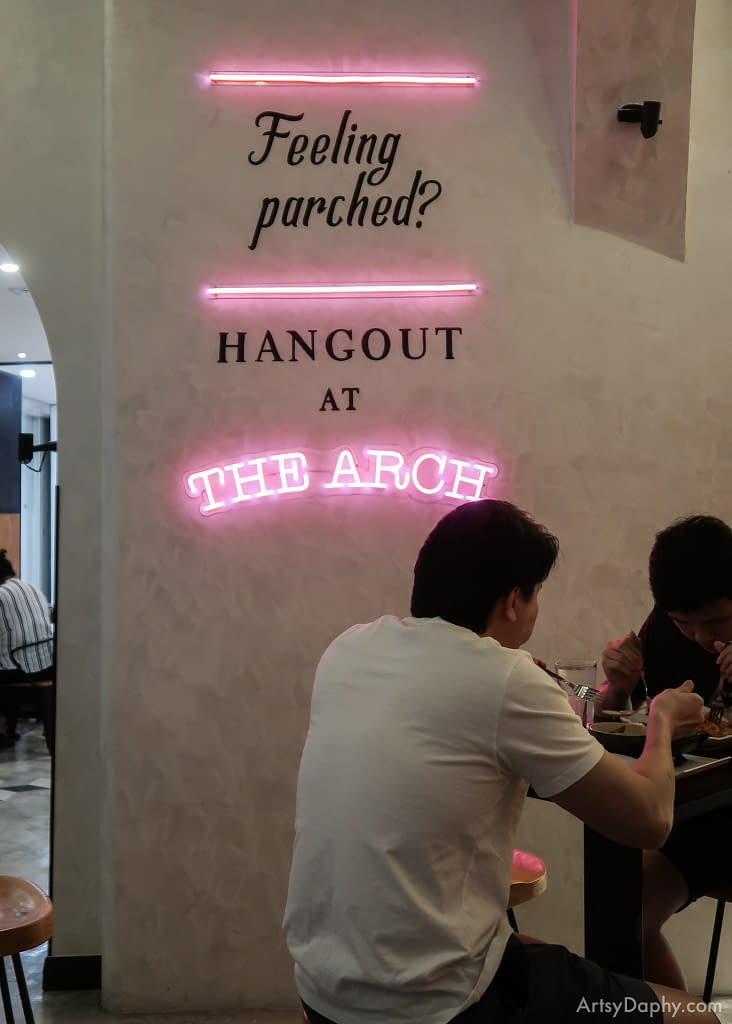 Neon lights and typography art which readsy 'feeling parched? Hangout at THE ARCH"