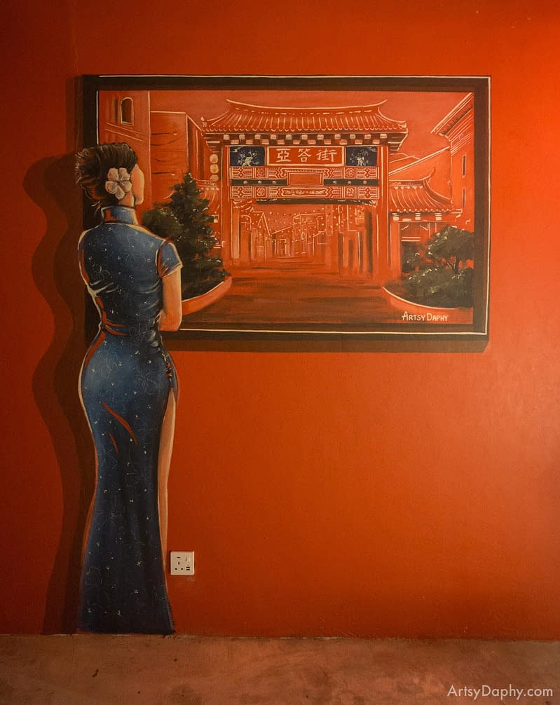 Eerie mural of woman looking at Carpenter Street painting inside a hidden bar